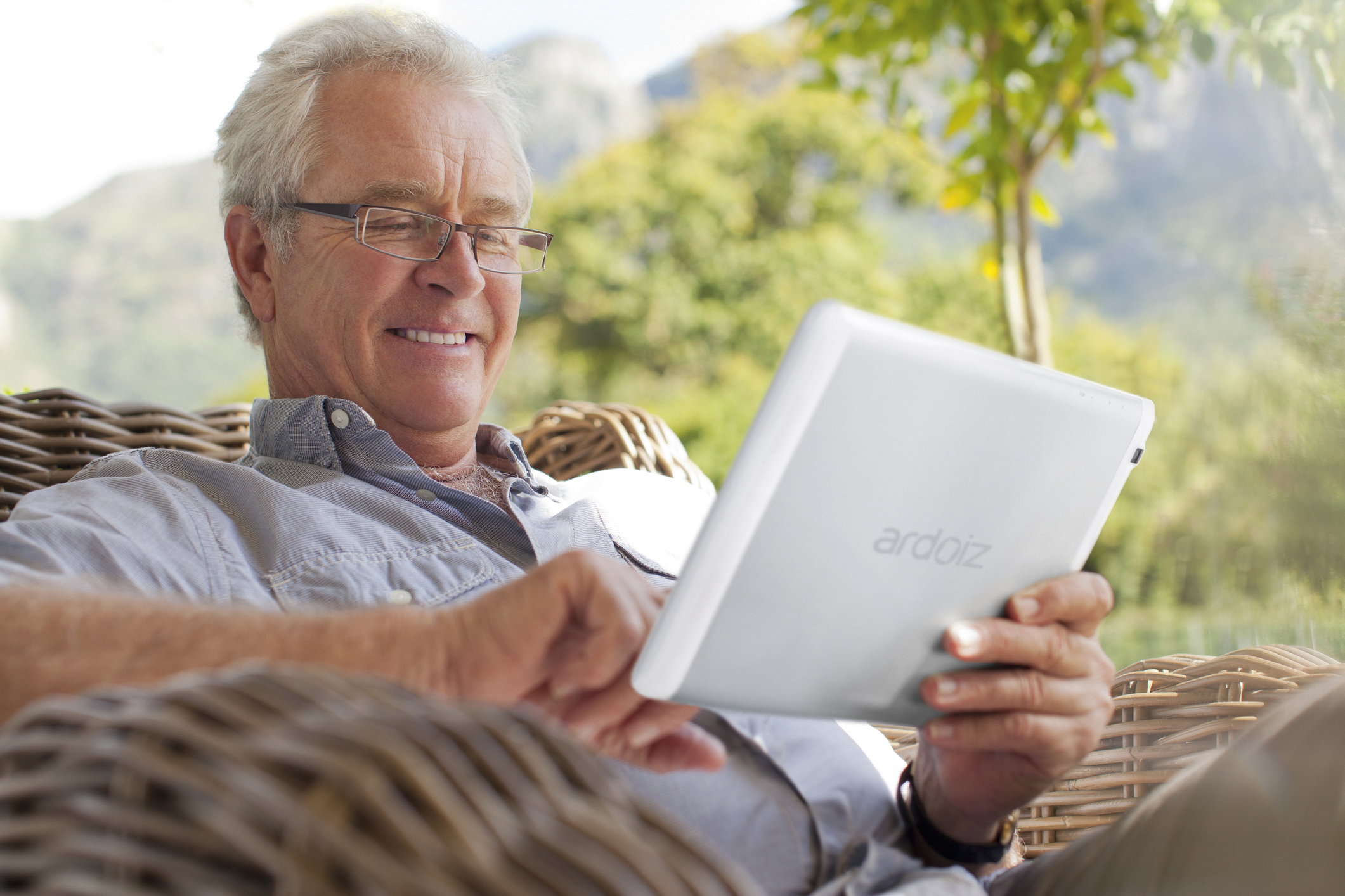 Smiling Senior Man Using Digital Tablet On Patio Top Topic